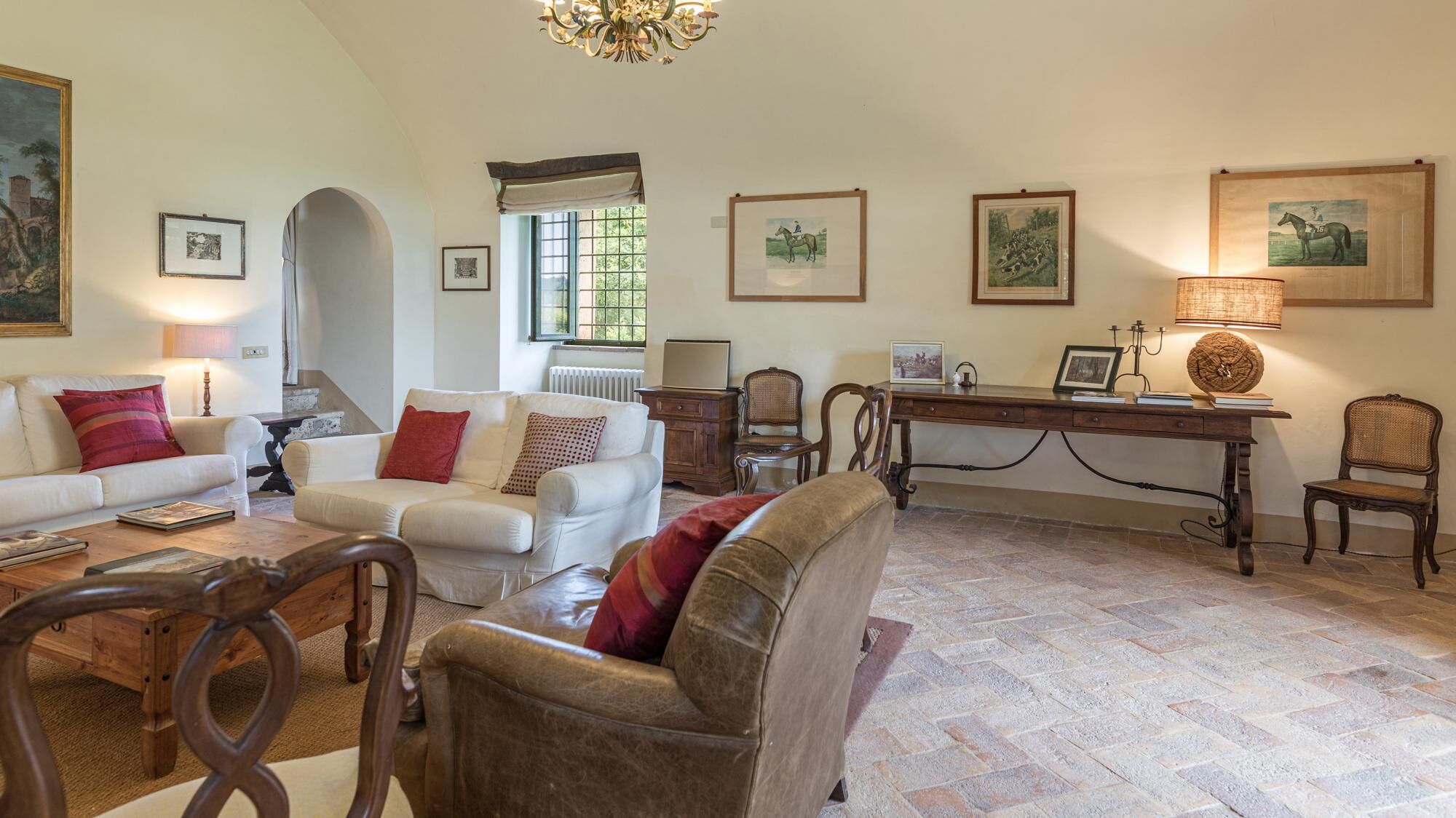 A spacious living room with a fireplace, a dining area, and a study with a desk and books.