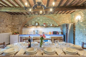 Enjoy meals in this warm and inviting kitchen, equipped with a sink, stove, and microwave, and a dining table for gatherings.