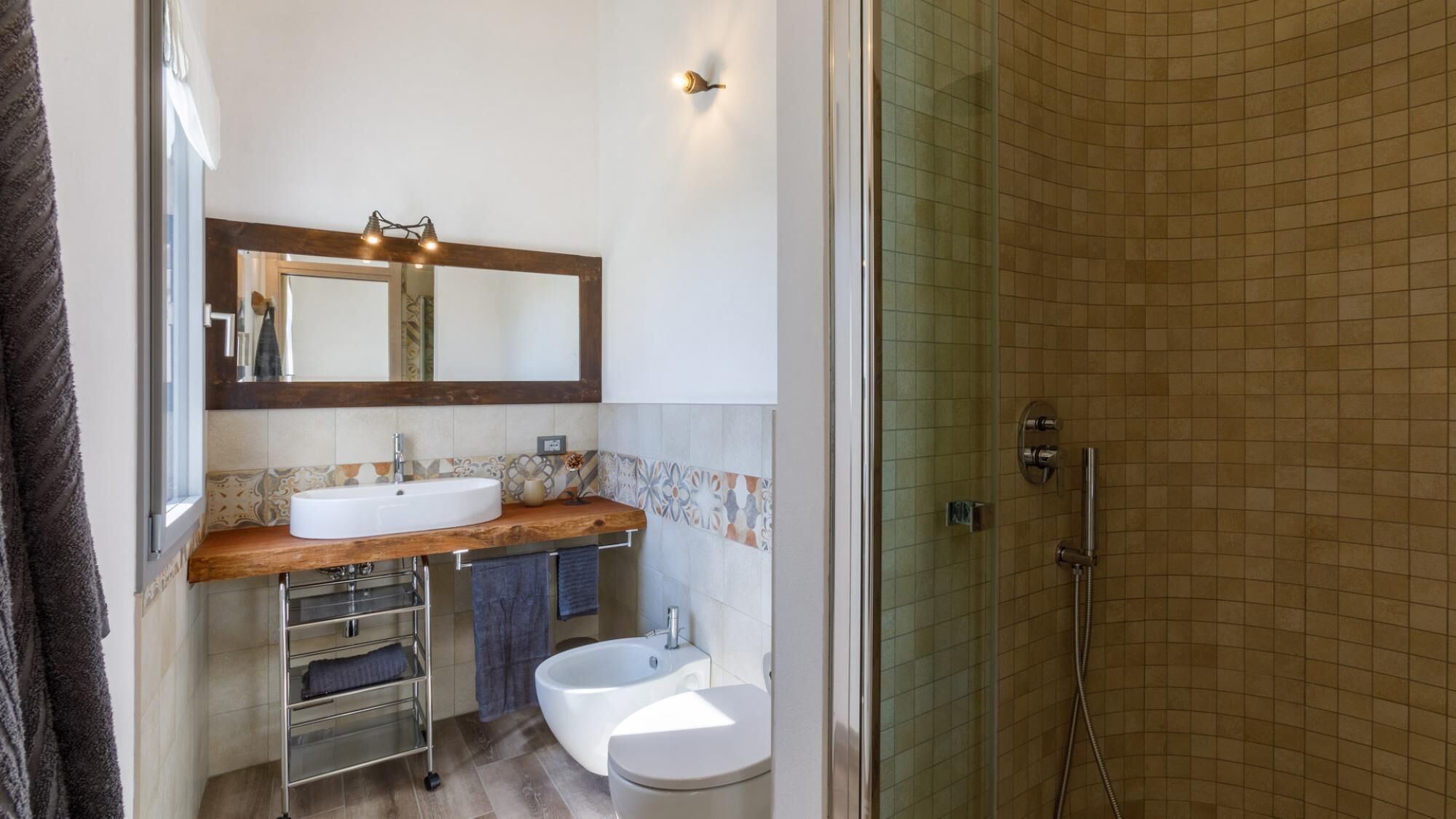 A bathroom with a large mirror, two sinks, a bathtub, and a shower.