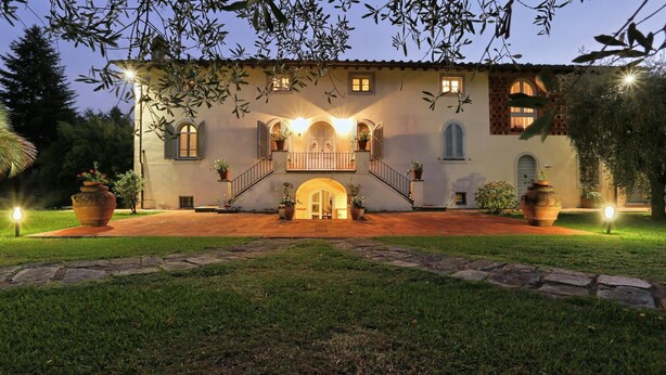 A villa with a central entrance, a staircase leading to a balcony, and a well-lit garden area. - Lu-b648-capa0at - Villa Alida 12 (Capannori)