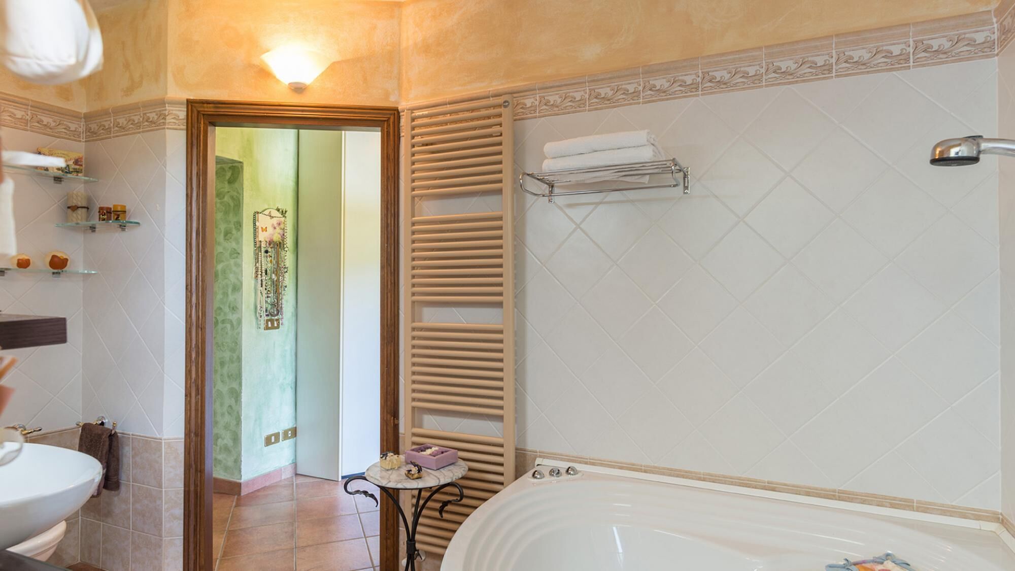 A bathroom with a bathtub, a toilet, a sink, and a shower area.