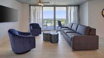 A modern living room with a grey sofa, a blue armchair, and a small coffee table.