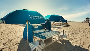 On the beach, sun-loungers, beach towels