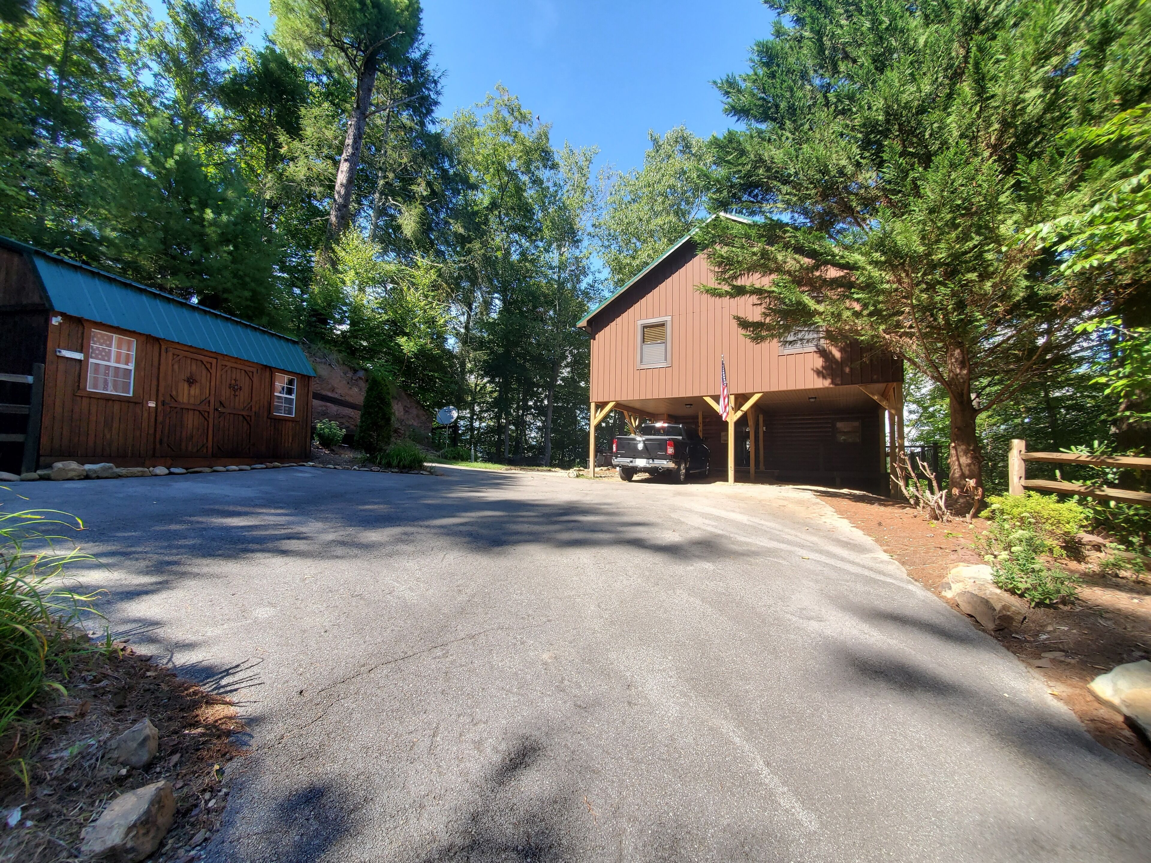 A two-story building with a garage and a truck parked in front.