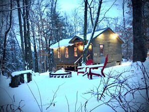 A cabin with a wooden exterior, surrounded by snow-covered trees. - Perfect Benezette Cabin.  Nestled in the woods, yet close to attractions.  
. (Benezette)