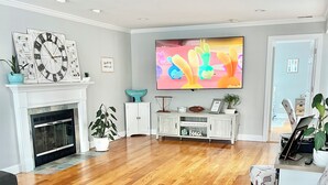 A living room with a fireplace, a TV, and a sofa. - Toddler Friendly, toys, boardwalk, beach, downtown, POOL, & clean! You get ALL!  (Point Pleasant Beach)