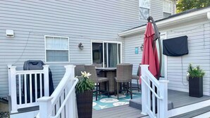 A deck with outdoor furniture, a grill, and a potted plant. - Toddler Friendly, toys, boardwalk, beach, downtown, POOL, & clean! You get ALL!  (Point Pleasant Beach)