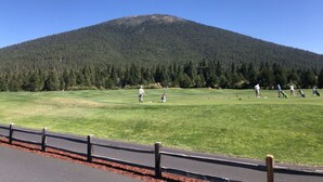 A golf course with a mountain in the background. - Black Butte Ranch A-Frame · Pools, Golf, Sleeps 8 (Sisters)