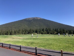 A golf course with a mountain in the background. - Black Butte Ranch A-Frame · Pools, Golf, Sleeps 8 (Sisters)