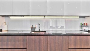 A modern kitchen with a central island, a built-in oven, and a stainless steel sink. - Casa Siesta with swimming pool, jacuzzi & garage (Štrika (Istria))