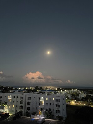 A night view of a residential area with buildings, a parking lot, and a visible moon. - Apartment with ocean view near Ceiba FerryTerminal (Ceiba)