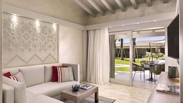 A modern living room with a sofa, coffee table, and a view of the outdoor patio.