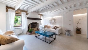 A spacious living room with a fireplace, a sofa set, and a coffee table.