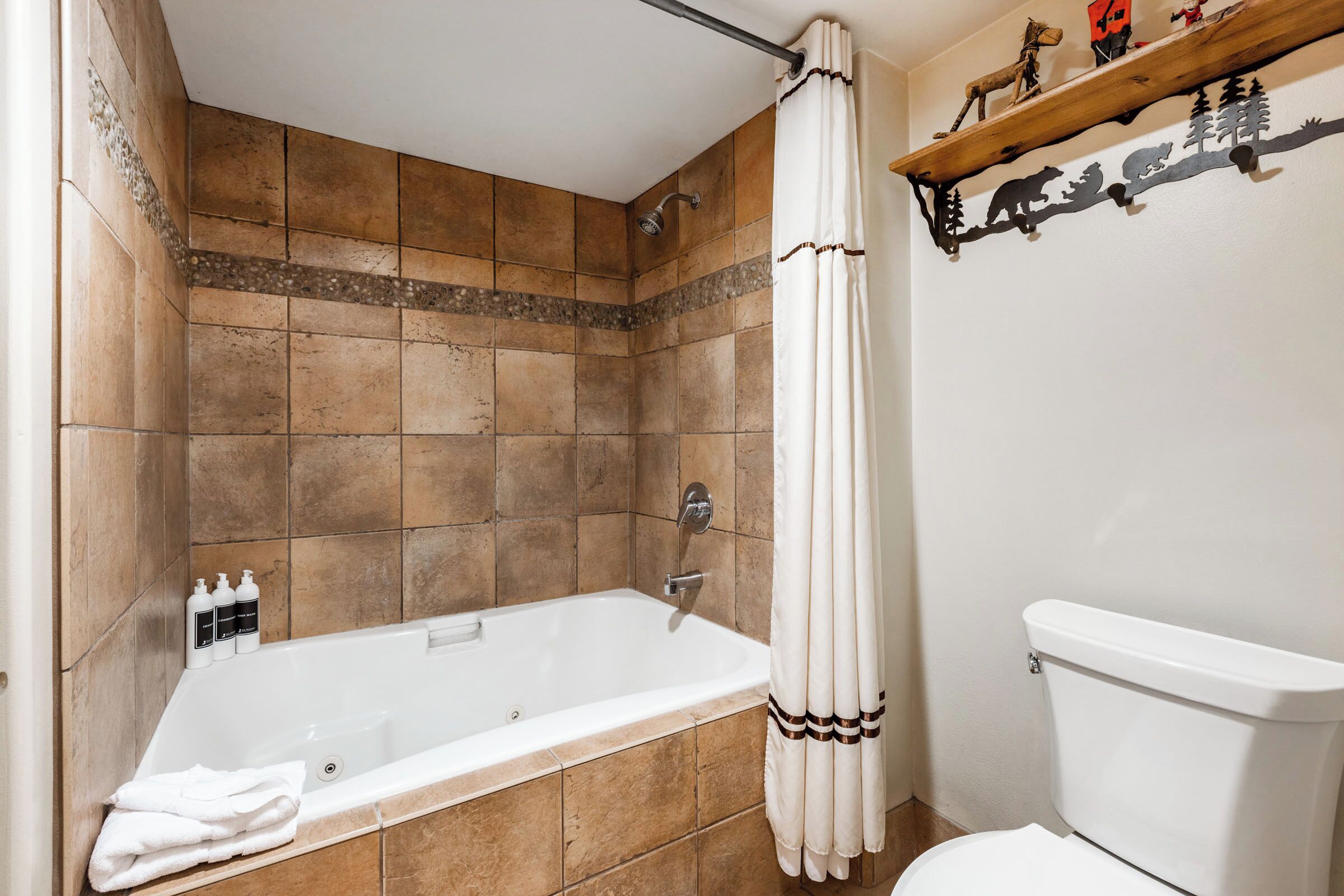 A bathroom with a bathtub, shower, and toilet.