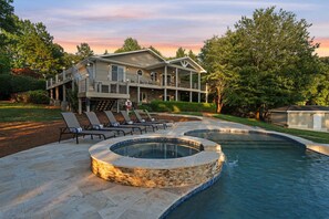A two-story house with a pool, outdoor seating, and a covered patio. - Casa Sul Lago by SoCharm | Lakefront Retreat |Pool| Dock (Troutman)