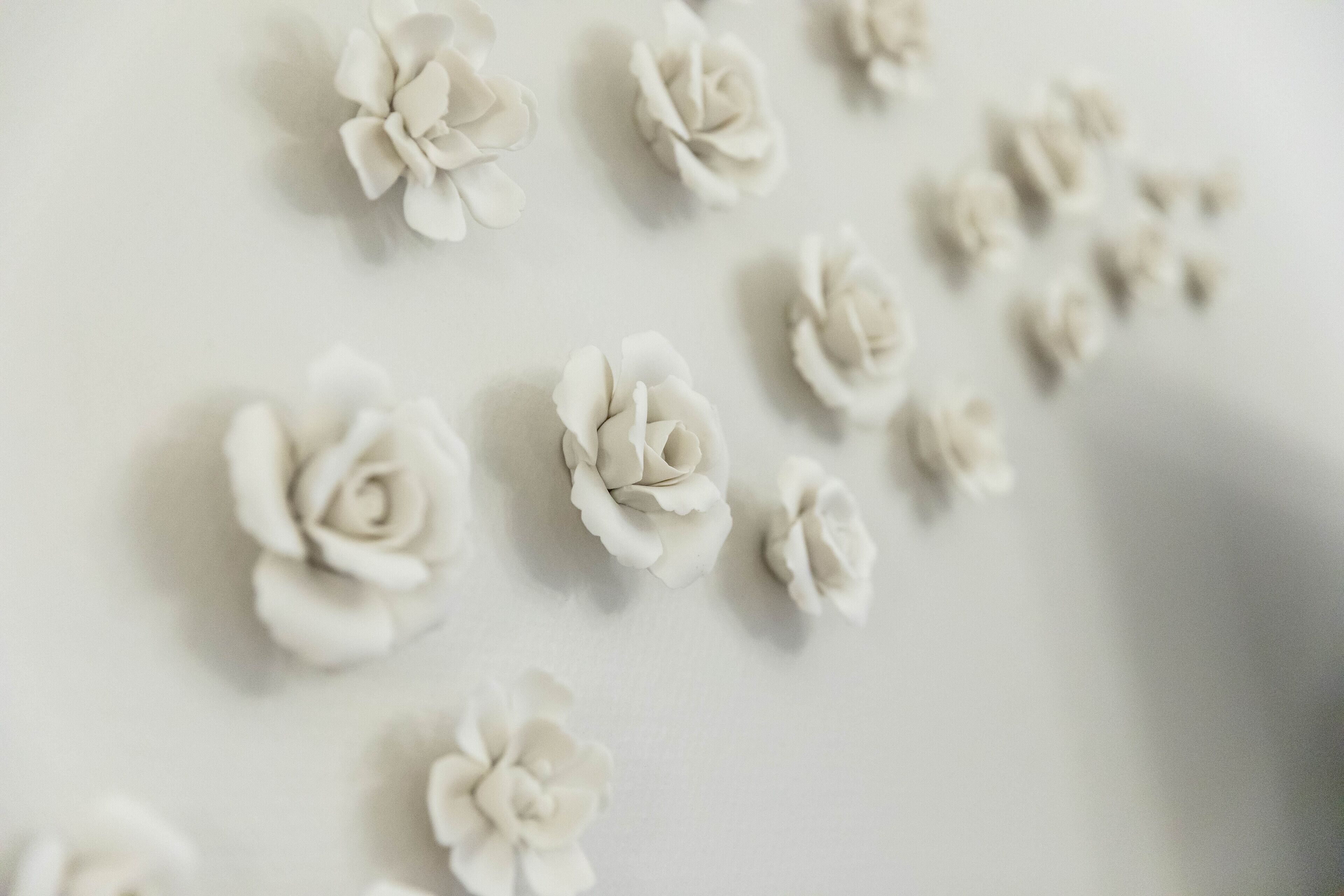 A close-up of several white paper flowers arranged on a surface.