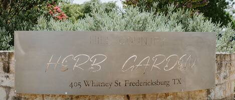 A sign for Herb Garden at Hill Country, located at 405 Whitney St, Fredericksburg, TX.