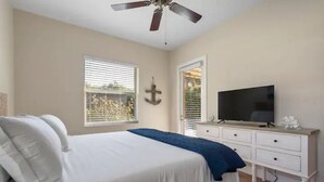 A bedroom with a bed, a TV, a ceiling fan, and a window with blinds. - Singer Island Beach Oasis: Heated Pool, Privacy Fence & Open Concept (West Palm Beach)
