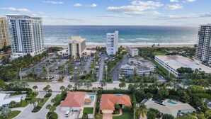A coastal area with high-rise buildings, a parking lot, and a beach in the background. - Singer Island Beach Oasis: Heated Pool, Privacy Fence & Open Concept (West Palm Beach)