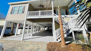 A two-story house with a covered patio and a balcony. - Fabulous 4 bedroom house in North Myrtle Beach (North Myrtle Beach)