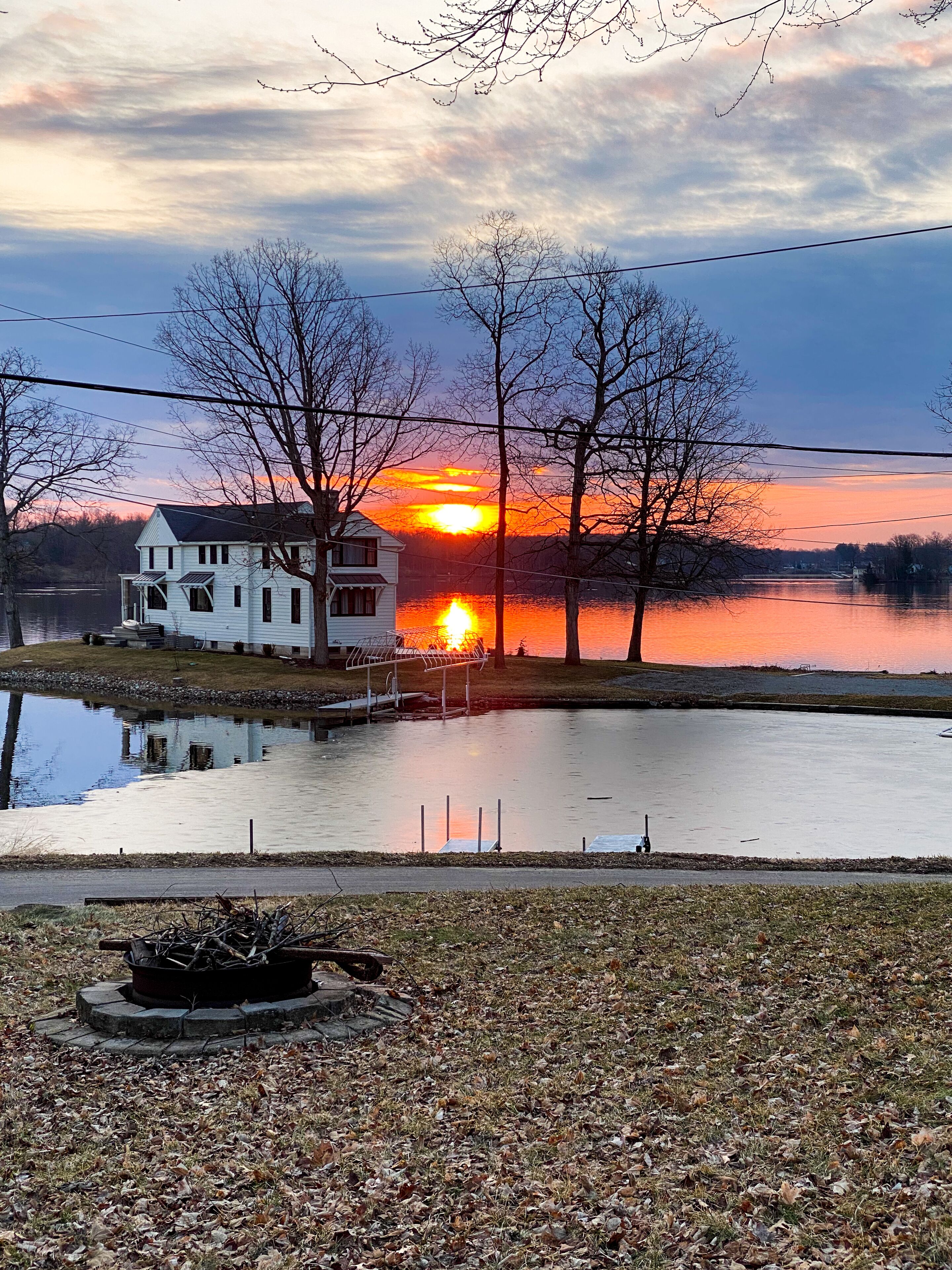 A house by a lake at sunset.
