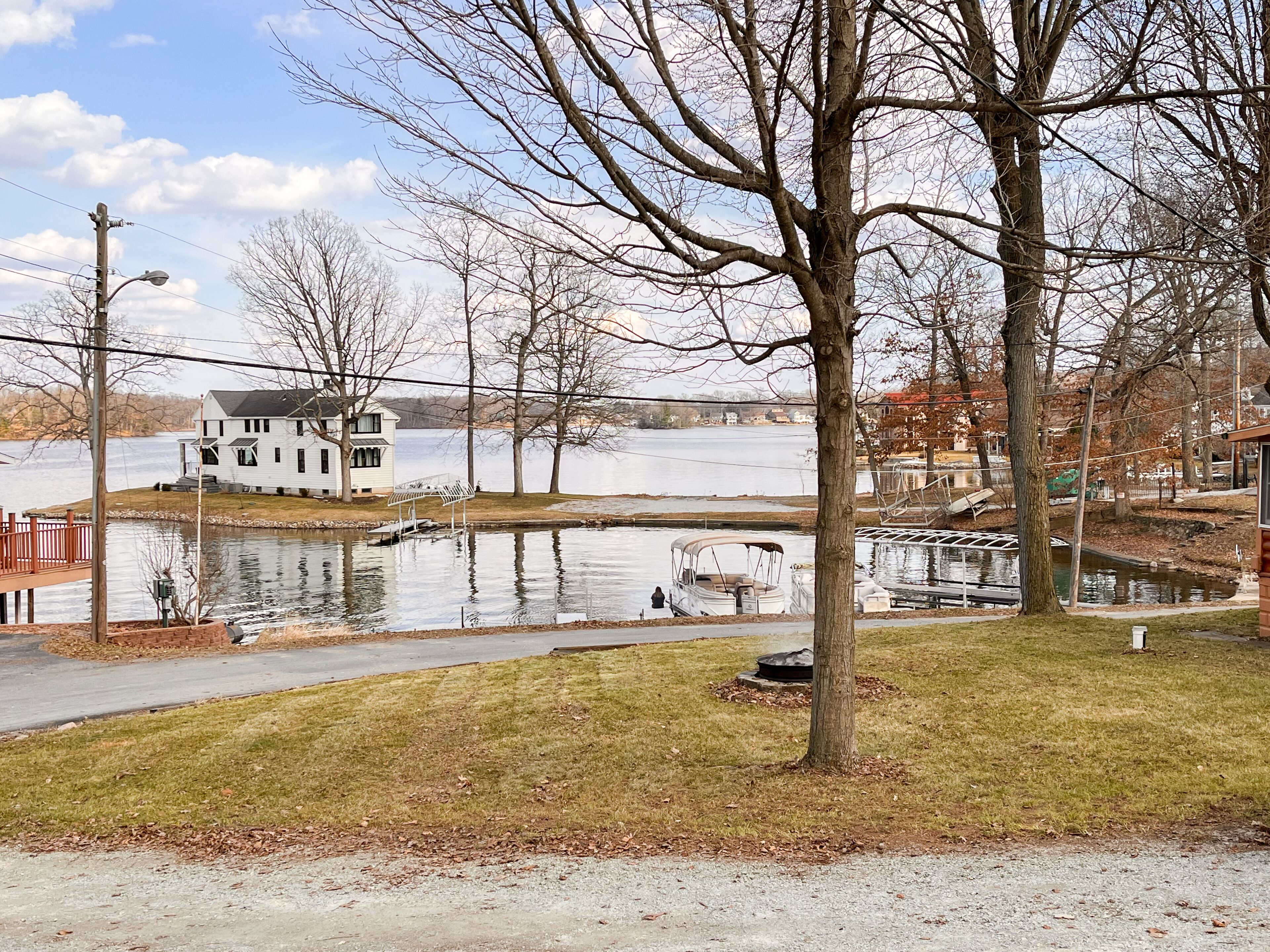 A house by a lake with a dock and a small boat.