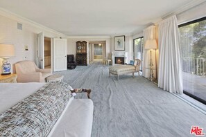 Relax in this elegantly furnished living room with a plush sofa set and traditional cabinet.
