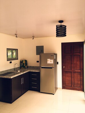 Fridge, microwave, coffee/tea maker, cookware/dishes/utensils