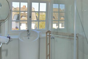 A bathroom with a large sink, a mirror, and a window. - Rüm Hart Traumblick Ost - Rüm Hart Traumblick Ost RUE 1 (Sylt)