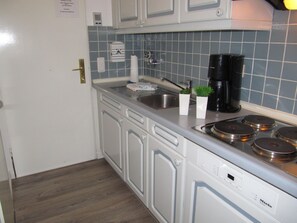 Fridge, stovetop, dishwasher, coffee/tea maker