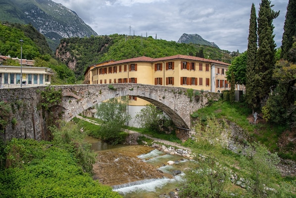A stone bridge over a river with buildings on either side.