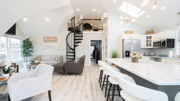 A modern kitchen with white cabinets, a stainless steel refrigerator, and a built-in microwave. - New Lake House w/ Game Room & Stunning Views (Preston)