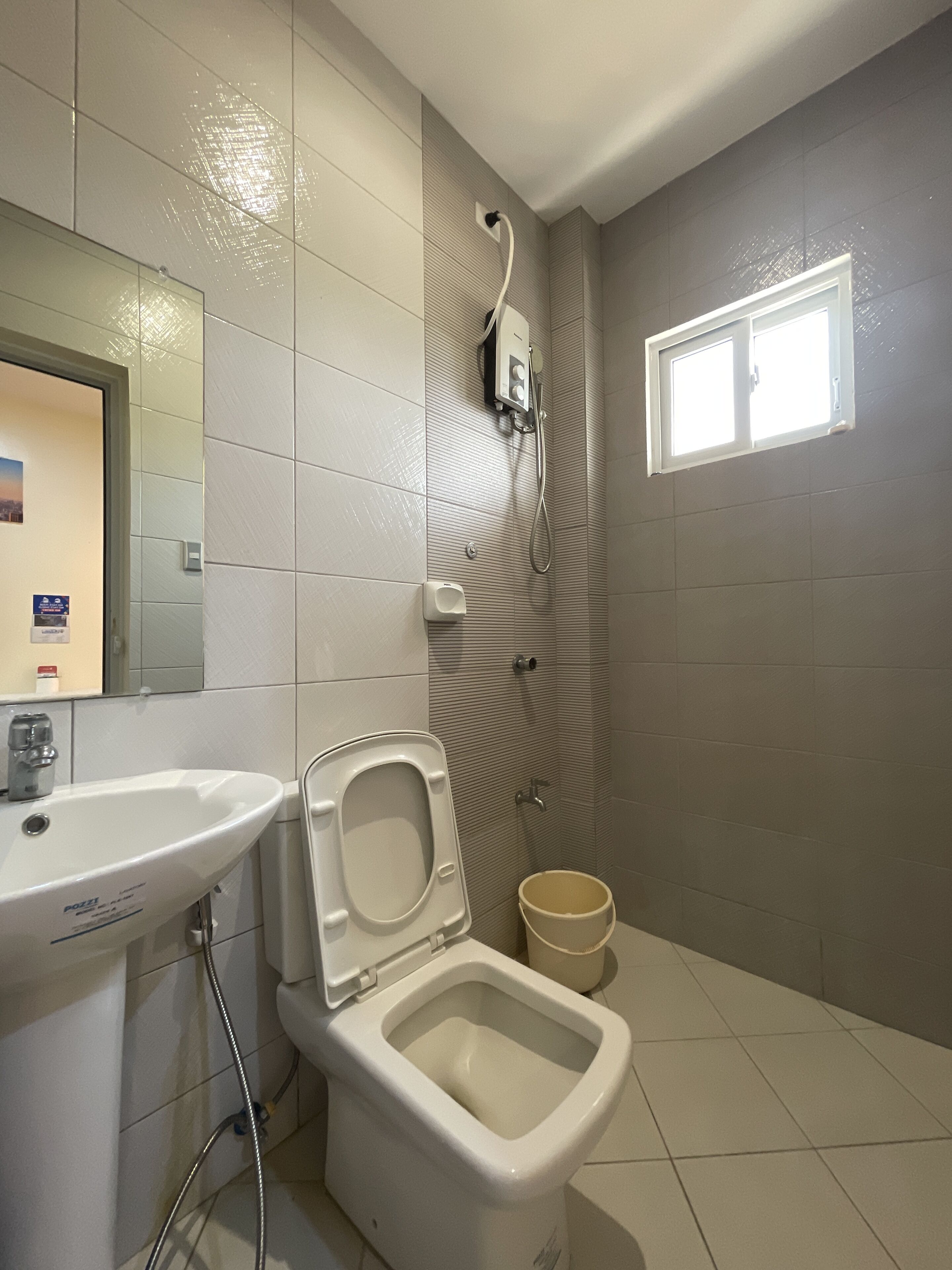 A bathroom with a toilet, bidet, and sink.