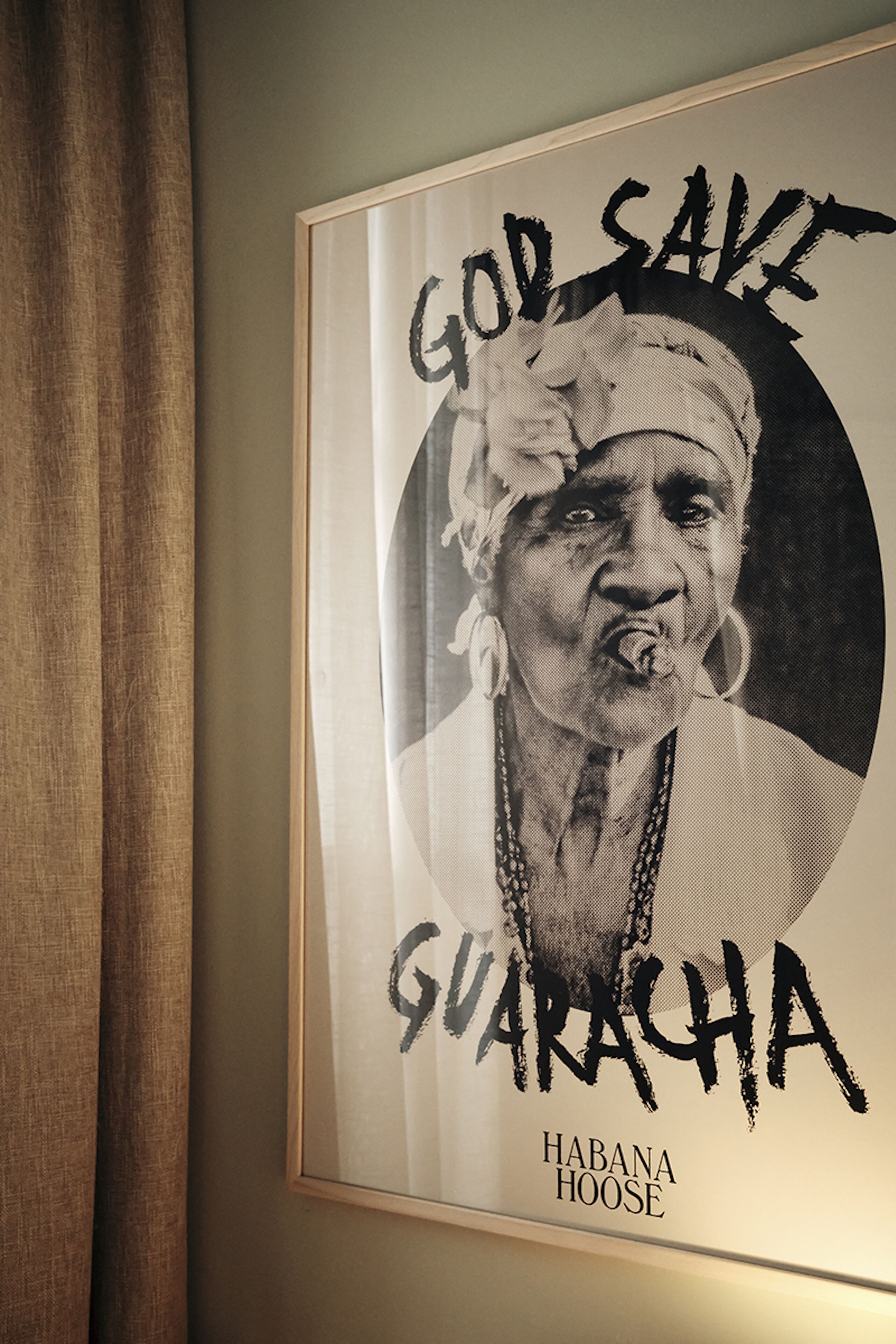 A framed poster with text and a partial image of a person.