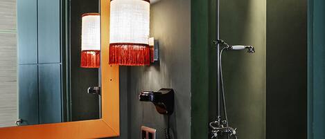 Une salle de bain avec un lavabo, un miroir et une douche.