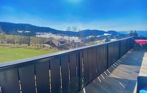 Enjoy the serene view of rolling hills and lush green fields from this balcony.