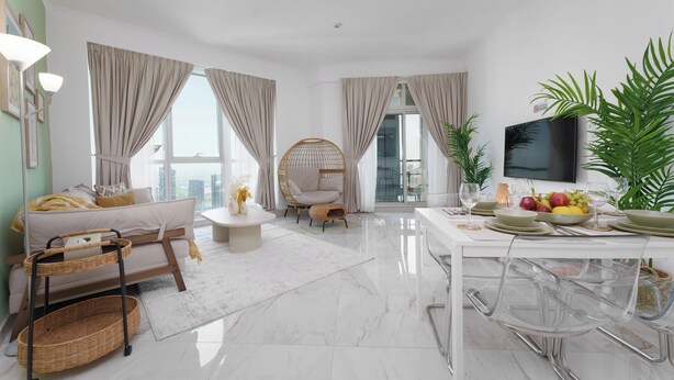 A modern living room with a sofa, a wicker side table, a round wicker chair, a dining table with clear chairs, and a flat-screen TV. - Marco Polo - Stylish & Spacious 2 BR with Marina + City Views (Dubai)