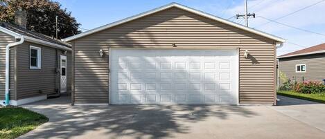 A single-story house with a garage, a front door, and a small porch area.
