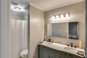 Enjoy a luxurious bathroom experience with a dual sink vanity, large mirror, and ample storage for toiletries.