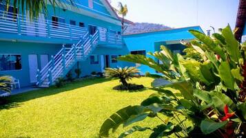 Stunning two-story building with lush green surroundings and a beautiful staircase.