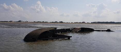 A coastal scene with a partially submerged structure in the water.