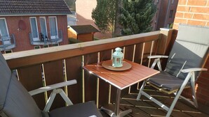 A wooden deck with a table and two chairs. - Domicil - Evening sun - "Domicil" Enjoy the evening sun! (Dahme)