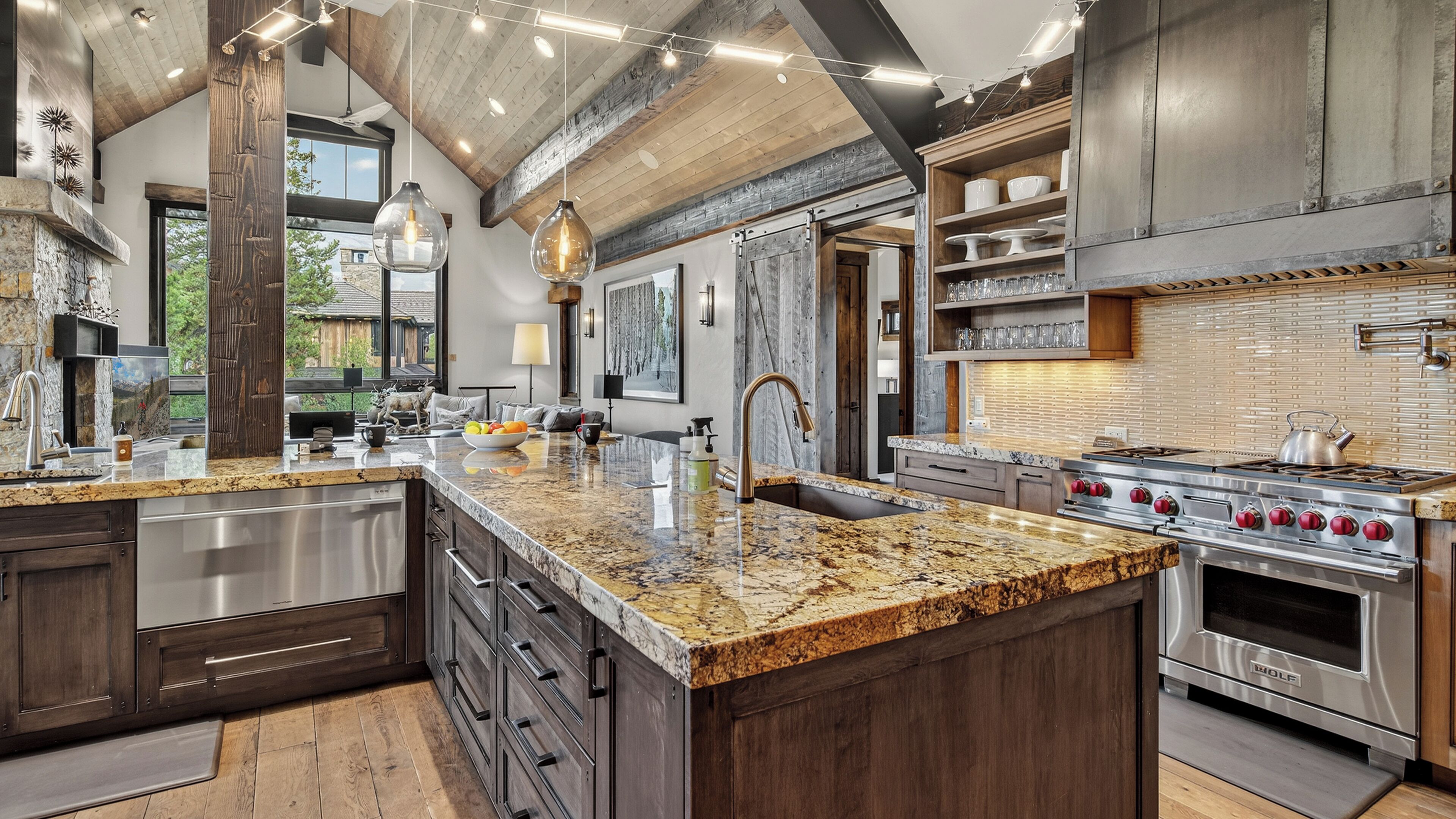A spacious kitchen with granite countertops, stainless steel appliances, and a large island.