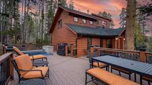 A log cabin with a deck, outdoor seating, and a hot tub. - Mtn Views + Hot Tub | Quicksilver Lodge (Breckenridge)