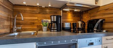 Fridge, stovetop, dishwasher, coffee/tea maker