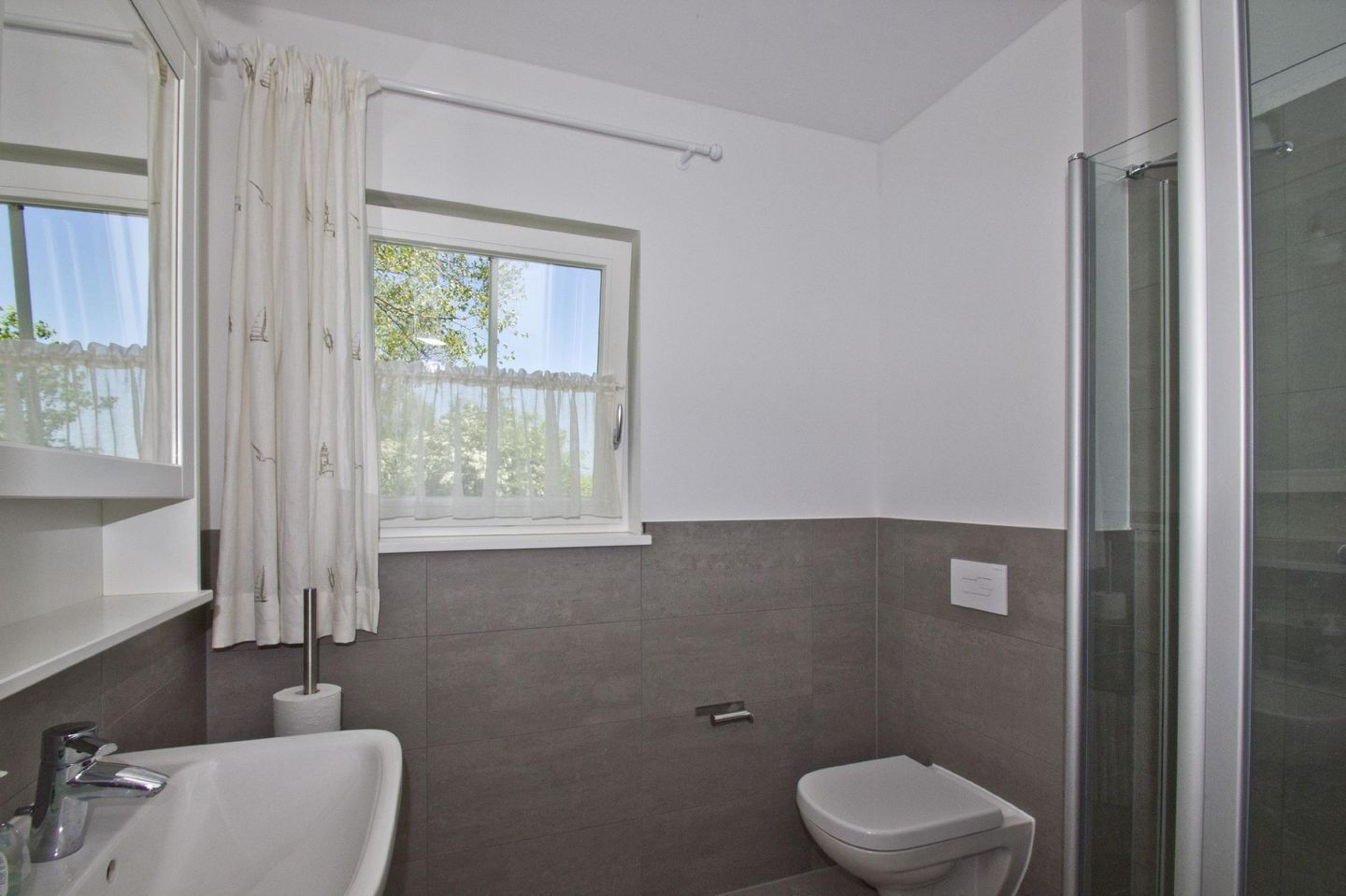A bathroom with a bathtub, toilet, and a shower area.