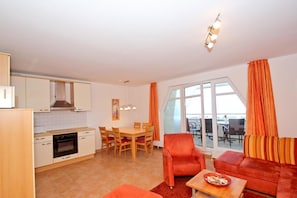 A compact living space with a kitchen, dining area, and seating area.