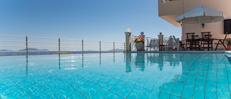 Relax by the pool with a view of the distant mountains.