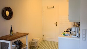 A compact kitchen with a wooden countertop, a sink, and a coffee maker.