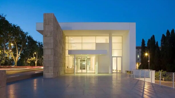 A modern building with a glass entrance and a stone facade. - Spanish steps luxury loft apartment (Roma)